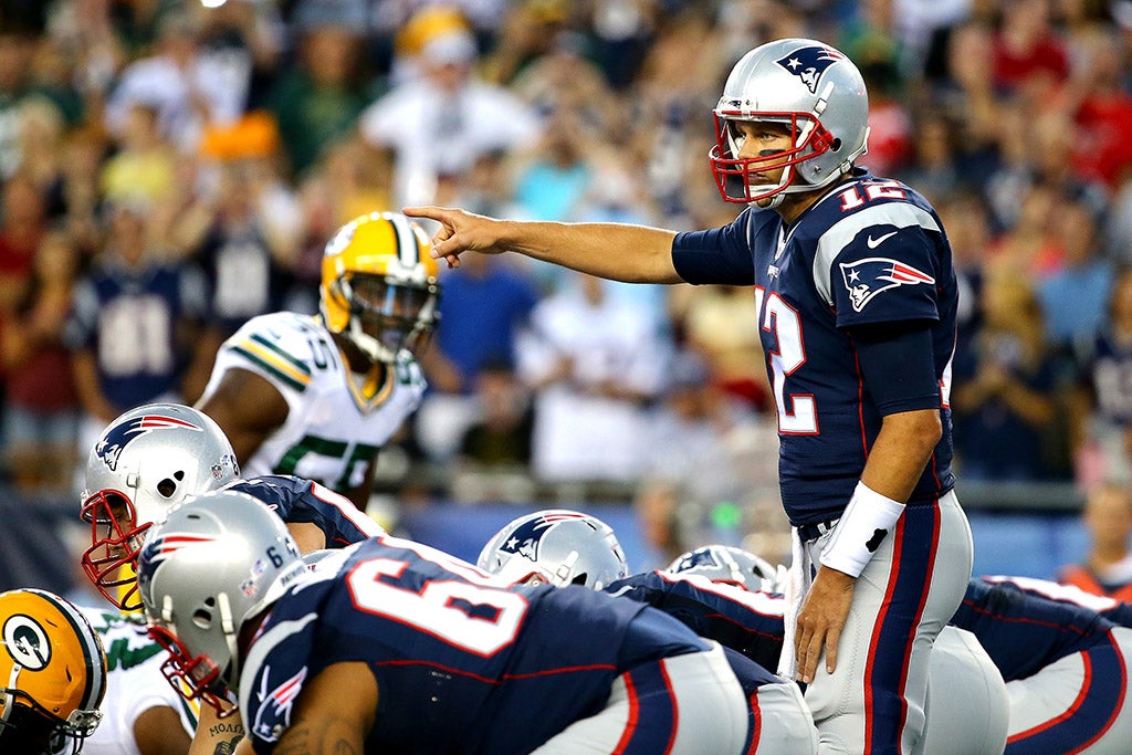 FOXBORO, MA - AUGUST 13, 2015: Tom Brady of the New England Patriots gestures at the line of scrimmage in the first quarter against the Green Bay Packers during a preseason game at Gillette Stadium. (Photo by Maddie Meyer/Getty Images)