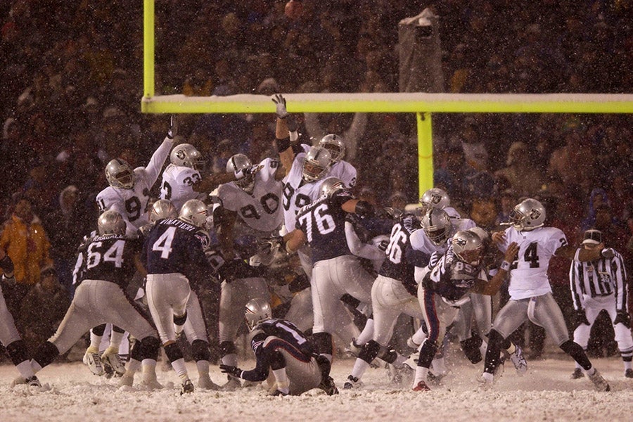 Adam Vinatieri of the New England Patriots kicks the game-winning field goal against the Oakland Raiders during the AFC playoff game at Foxboro Stadium in Foxboro, Massachusetts on Jan. 19, 2002. (Ezra Shaw/ Getty Images)