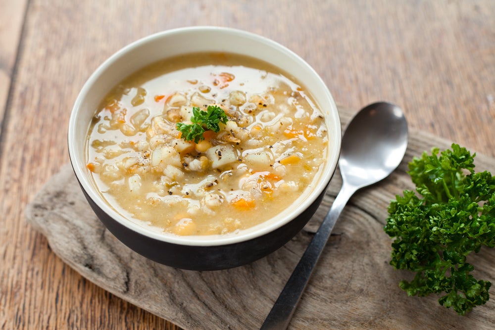 barley soup on wooden serving tray