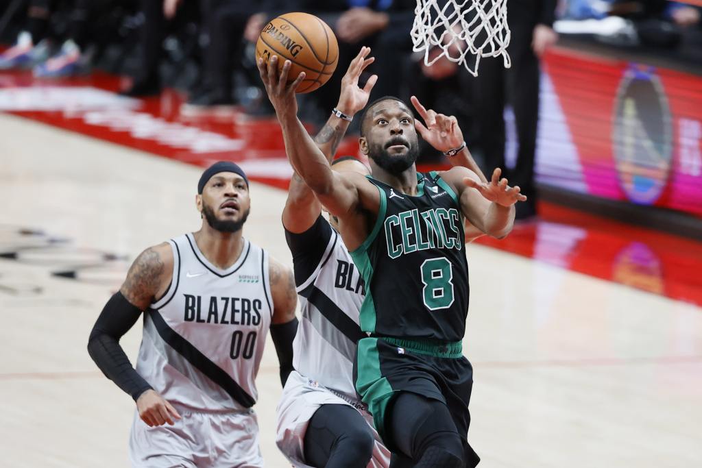 Apr 13, 2021; Portland, Oregon, USA; Boston Celtics point guard Kemba Walker (8) goes to the basket past Portland Trail Blazers small forward Norman Powell (24) during the second half at Moda Center. Mandatory Credit: Soobum Im-USA TODAY Sports