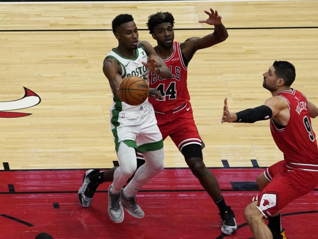 May 7, 2021; Chicago, Illinois, USA; Boston Celtics forward Aaron Nesmith (26) is defended by Chicago Bulls forward Patrick Williams (44) and center Nikola Vucevic (9) during the first quarter at United Center.