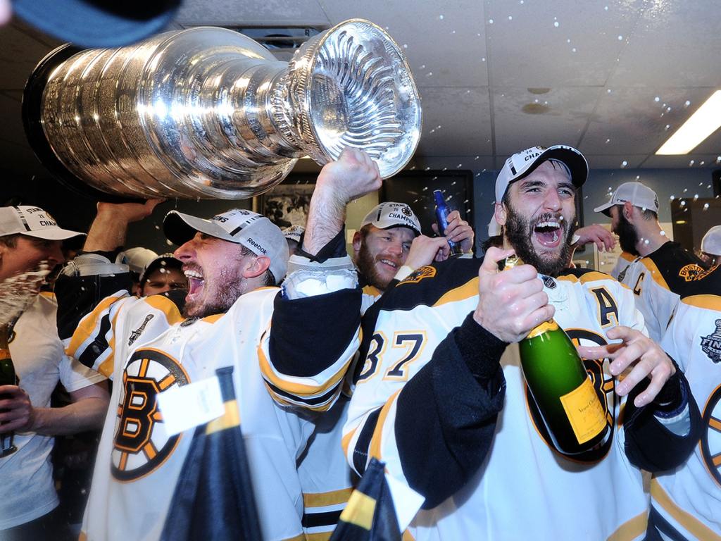 VANCOUVER, BC - JUNE 15: Brad Marchand #63 and Patrice Bergeron #37 of the Boston Bruins celebrate with the Stanley Cup in th locker room after Game Seven of the 2011 NHL Stanley Cup Final at Rogers Arena on June 15, 2011 in Vancouver, British Columbia, Canada. (Photo by Harry How/Getty Images)