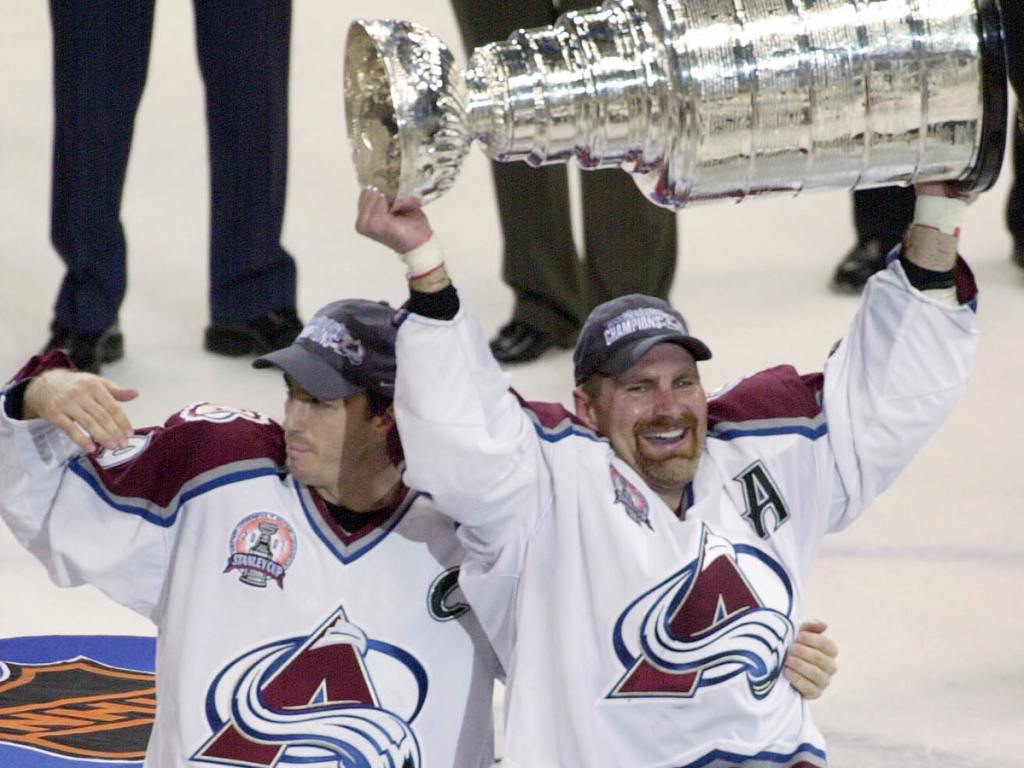 Joe Sakic #19 and Ray Borque #77 (right) of the Colorado Avalanche hold up the Stanley Cup after defeating the New Jersey Devils in game seven of the NHL Stanley Cup Finals at Pepsi Center in Denver, Colorado on June 9, 2001. The Avalanche won 3-1 to take the series 4-3.(Matthew Stockman/Allsport)