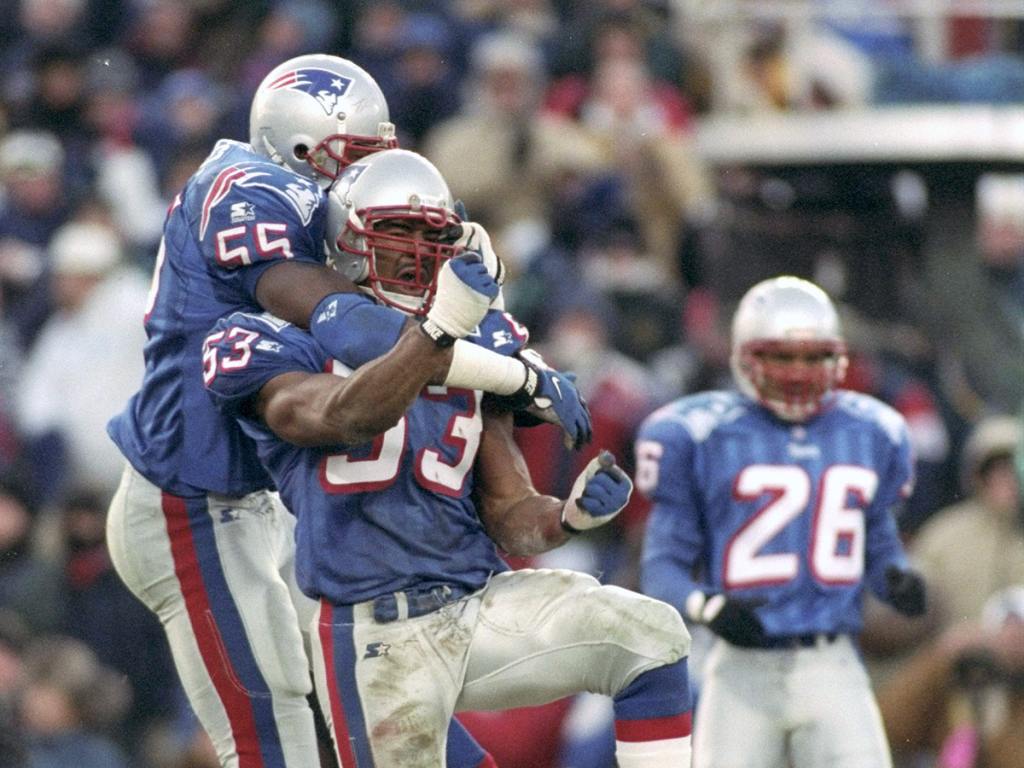 Defensive back Willie McGinest #55 and linebacker Chris Slade #53 both of the New England Patriots jump for joy at the Patriots stopping the Jacksonville Jaguars on the 4th down in the AFC Championship game at Foxboro Stadium in Foxboro, Massachusetts on Jan. 12, 1997. The Patriots won 20-16. (Photo by Rick Stewart/Getty Images)