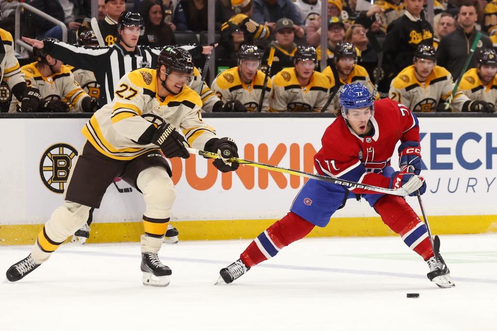 Nov 18, 2023; Boston, Massachusetts, USA; Boston Bruins defenseman Hampus Lindholm (27) tries to stop Montreal Canadiens center Jake Evans (71) during the first period at TD Garden. Mandatory Credit: Winslow Townson-USA TODAY Sports