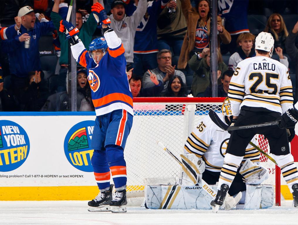 ELMONT, NEW YORK - DECEMBER 15: Anders Lee #27 of the New York Islanders celebrates a powerplay goal by Bo Horvat #14 at 5:06 of the third period against the Boston Bruins at UBS Arena on December 15, 2023 in Elmont, New York. (Photo by Bruce Bennett/Getty Images)