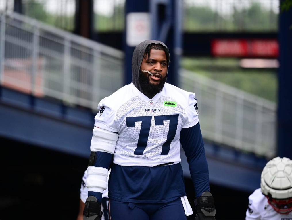 Jul 24, 2024; Foxborough, MA, USA; New England Patriots offensive tackle Chukwuma Okorafor (77) walks to the practice field during training camp at Gillette Stadium. Credit: Eric Canha-USA TODAY Sports