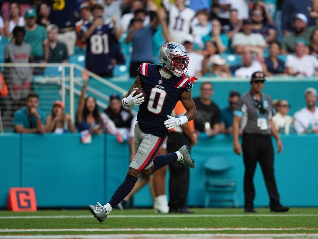 Nov 24, 2024; Miami Gardens, Florida, USA; New England Patriots cornerback Christian Gonzalez (0) runs the ball for a touchdown after recovering a fumble against the Miami Dolphins during the second half at Hard Rock Stadium. Credit: Jasen Vinlove-Imagn Images