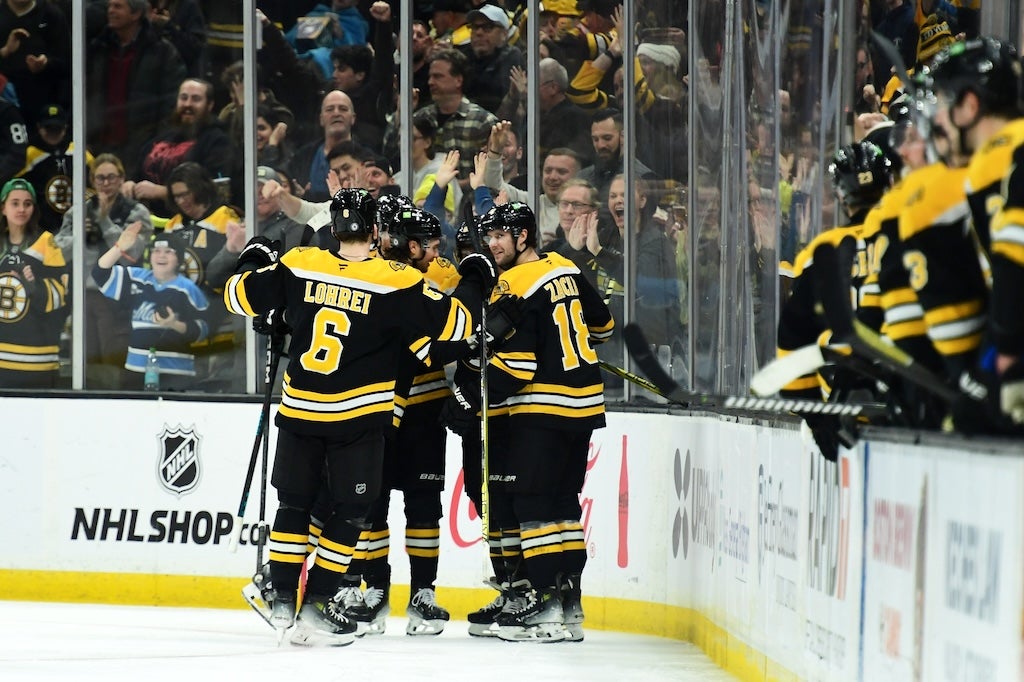 Dec 28, 2024; Boston, Massachusetts, USA; Boston Bruins defenseman Mason Lohrei (6) and center Pavel Zacha (18) celebrate a goal by right wing David Pastrnak (88) during the second period against the Columbus Blue Jackets at TD Garden. Mandatory Credit: Bob DeChiara-Imagn Images