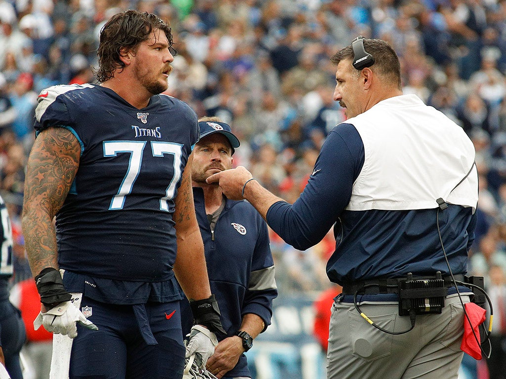 NASHVILLE, TENNESSEE - OCTOBER 27: Head coach Mike Vrabel of the Tennessee Titans speaks to Taylor Lewan #77 during the second half of a game against the Tampa Bay Buccaneers at Nissan Stadium on October 27, 2019 in Nashville, Tennessee. (Photo by Frederick Breedon/Getty Images)