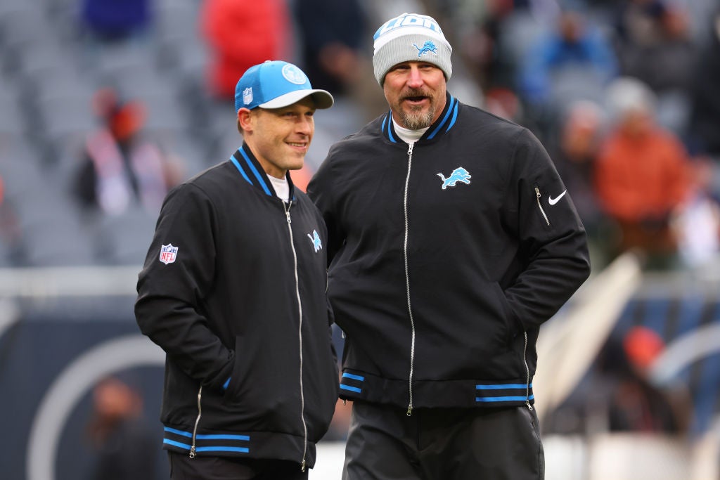 CHICAGO, ILLINOIS - DECEMBER 10: Head coach Dan Campbell of the Detroit Lions speaks with offensive coordinator Ben Johnson prior to the game against the Chicago Bears at Soldier Field on December 10, 2023 in Chicago, Illinois. (Photo by Michael Reaves/Getty Images)