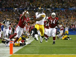 James Harrison of the Pittsburgh Steelers scores a touchdown after running back an interception for 100 yards against the Arizona Cardinals in Super Bowl XLIII. (Photo by Al Bello/Getty Images)