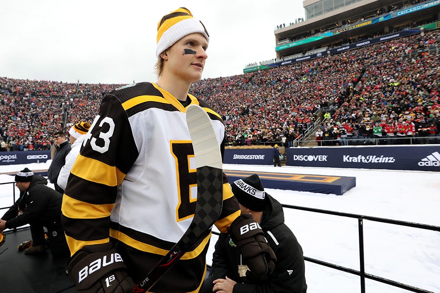 Danton Heinen of the Boston Bruins walks to the rink before the 2019 Bridgestone NHL Winter Classic against the Chicago Blackhawks at Notre Dame Stadium on January 01, 2019 in South Bend, Indiana. (Photo by Gregory Shamus/Getty Images)