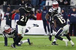 Running back Mark Ingram II of the Baltimore Ravens rushes past cornerback Stephon Gilmore of the New England Patriots in the first half at M&T Bank Stadium on November 3, 2019 in Baltimore, Maryland. (Photo by Todd Olszewski/Getty Images)