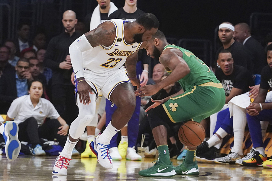 Feb 23, 2020; Los Angeles, California, USA; Los Angeles Lakers forward LeBron James (23) and Boston Celtics guard Brad Wanamaker (9) battle for the ball in the first half at Staples Center. Mandatory Credit: Kirby Lee-USA TODAY Sports
