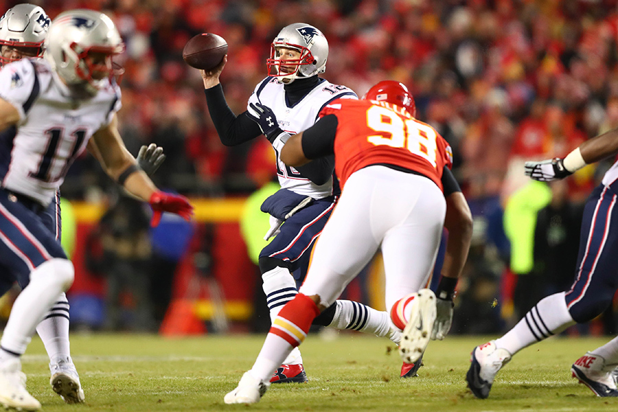 Jan 20, 2019; Kansas City, MO, USA; New England Patriots quarterback Tom Brady (12) looks to pass as Kansas City Chiefs nose tackle Xavier Williams (98) closes in during the first quarter of the AFC Championship game at Arrowhead Stadium. Mandatory Credit: Mark Rebilas-USA TODAY Sports