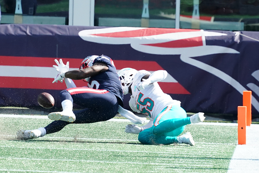 Sep 13, 2020; Foxborough, Massachusetts, USA; New England Patriots wide receiver N'Keal Harry (15) fumbles the ball in the end zone for a touchback as Miami Dolphins outside linebacker Jerome Baker (55) defends at Gillette Stadium. Mandatory Credit: David Butler II-USA TODAY Sports