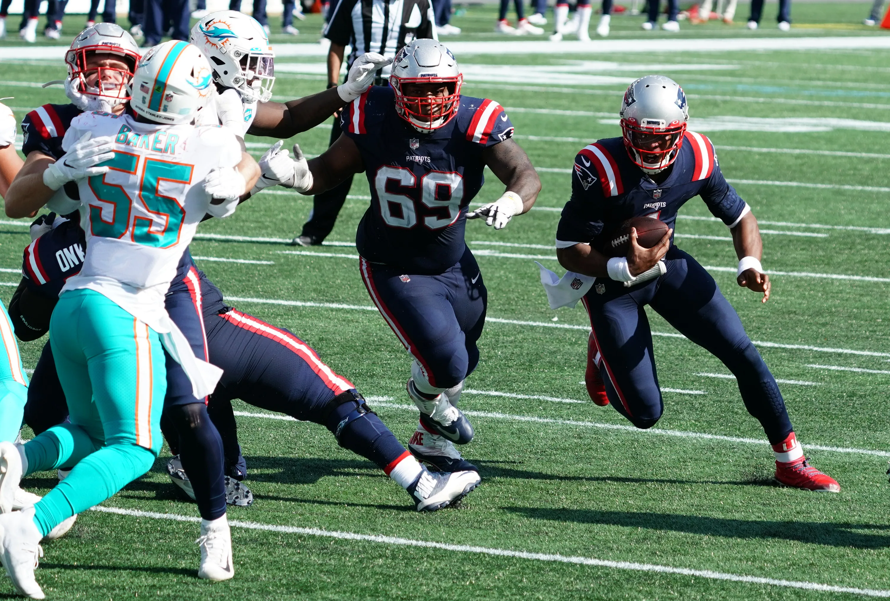 Patriots quarterback Cam Newton got effective blocking from rookie Michael Onwenu (left) on the offensive line. (David Butler II-USA TODAY Sports)