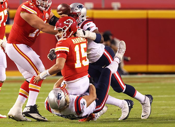 KANSAS CITY, MISSOURI - OCTOBER 05: Patrick Mahomes #15 of the Kansas City Chiefs is sacked by Chase Winovich #50 of the New England Patriots during the first half at Arrowhead Stadium on October 05, 2020 in Kansas City, Missouri. (Photo by Jamie Squire/Getty Images)