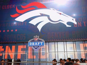 NFL Mock Draft: ARLINGTON, TX - APRIL 26: The Denver Broncos logo is seen on a video board during the first round of the 2018 NFL Draft at AT&T Stadium on April 26, 2018 in Arlington, Texas. (Photo by Tom Pennington/Getty Images)