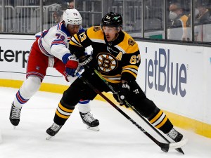May 8, 2021; Boston, Massachusetts, USA; New York Rangers defenseman K'Andre Miller (79) tries to reach around to stop Boston Bruins left wing Brad Marchand (63) during the first period at TD Garden. Mandatory Credit: Winslow Townson-USA TODAY Sports