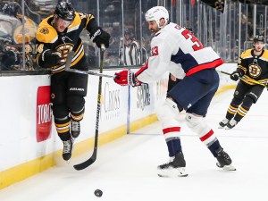 BOSTON, MA - MAY 21: Chris Wagner #14 of the Boston Bruins evades Zdeno Chara #33 of the Washington Capitals along the side boards during the first period of Game Four of the First Round of the 2021 Stanley Cup Playoffs at TD Garden on May 21, 2021 in Boston, Massachusetts. (Photo by Adam Glanzman/Getty Images)