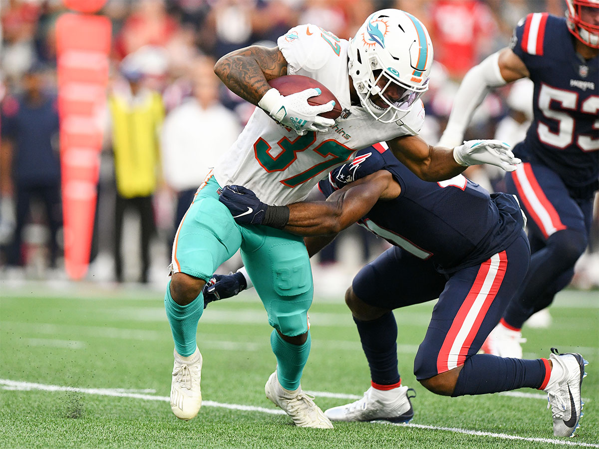 Sep 12, 2021; Foxborough, Massachusetts, USA; New England Patriots defensive back Adrian Phillips (21) tackles Miami Dolphins running back Myles Gaskin (37) during the second half at Gillette Stadium. Mandatory Credit: Brian Fluharty-USA TODAY Sports