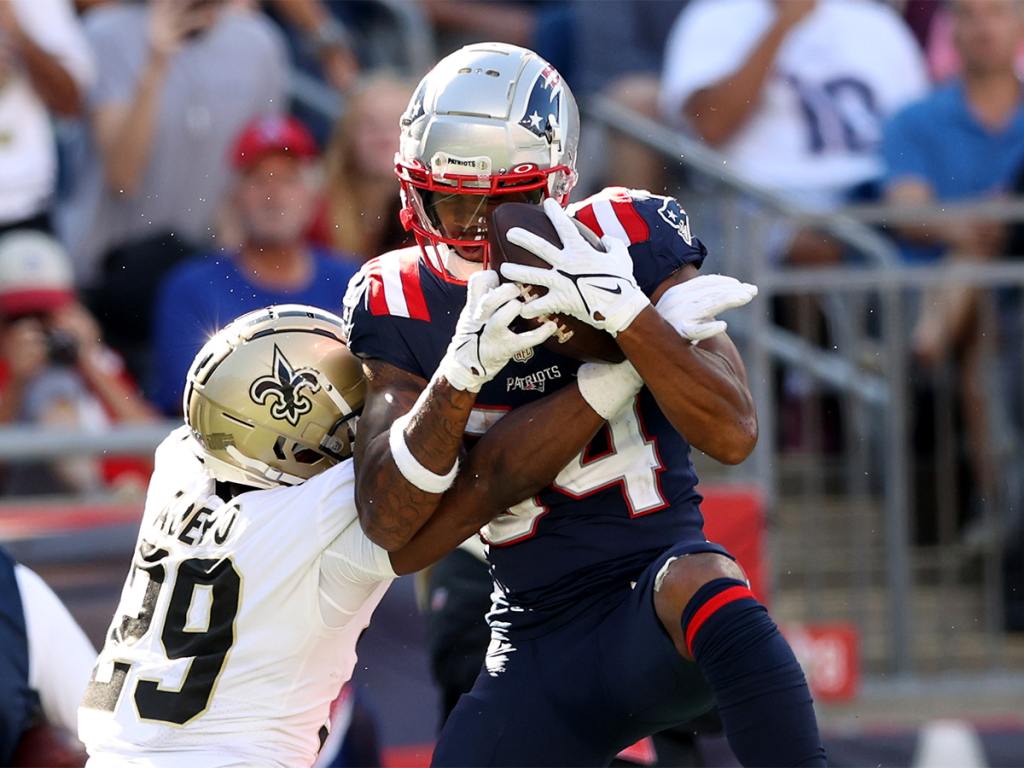 FOXBOROUGH, MASSACHUSETTS - SEPTEMBER 26: Kendrick Bourne #84 of the New England Patriots makes the catch and runs it in for a touchdown as Paulson Adebo #29 of the New Orleans Saints defends in the fourth quarter at Gillette Stadium on September 26, 2021 in Foxborough, Massachusetts. The New Orleans Saints beat the New England Patriots 28-13. (Photo by Elsa/Getty Images)