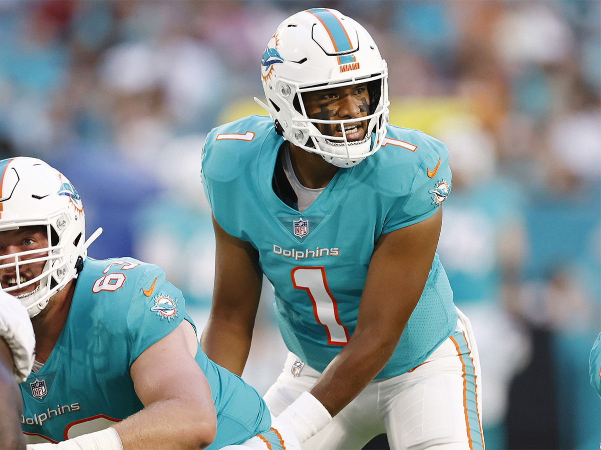 MIAMI GARDENS, FLORIDA - AUGUST 21: Tua Tagovailoa #1 of the Miami Dolphins looks on under center Michael Deiter #63 against the Atlanta Falcons during a preseason game at Hard Rock Stadium on August 21, 2021 in Miami Gardens, Florida. (Photo by Michael Reaves/Getty Images)