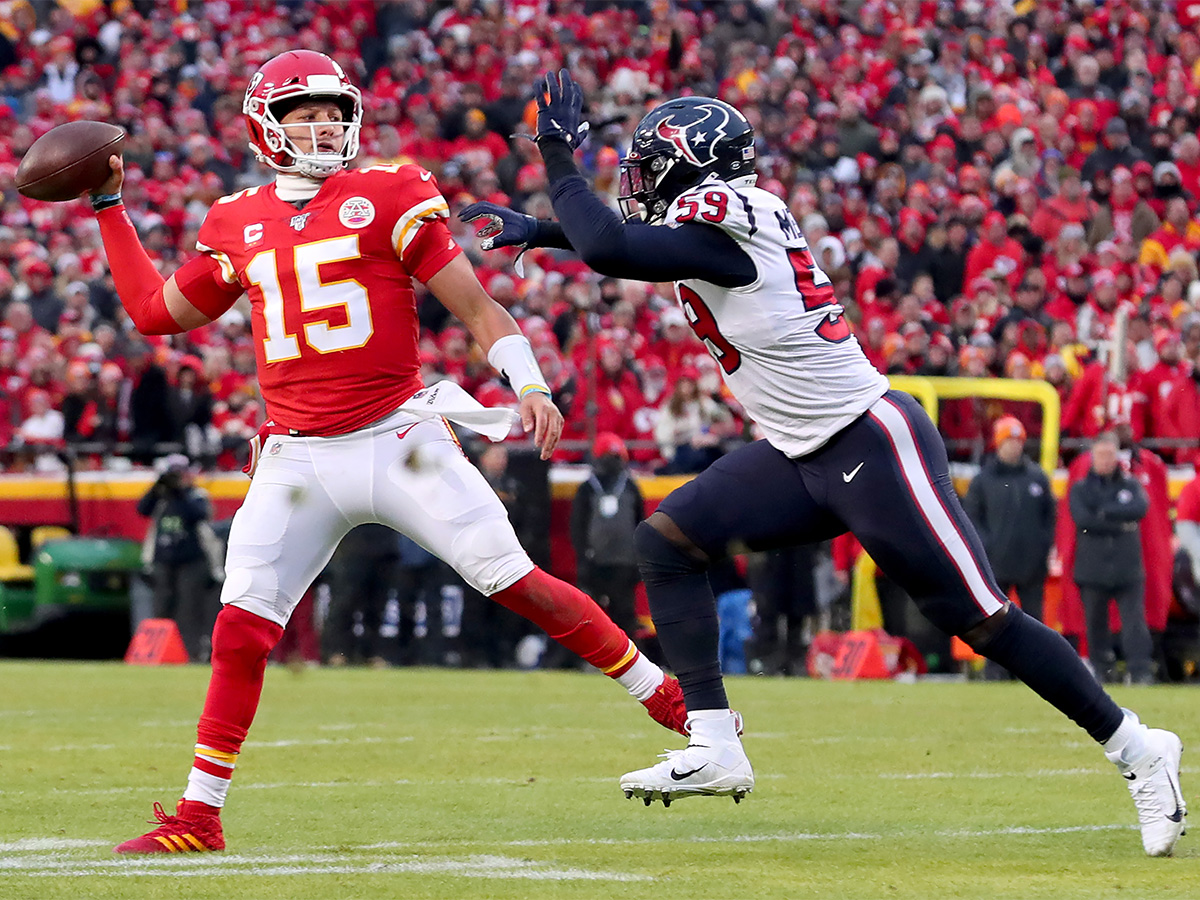 KANSAS CITY, MISSOURI - JANUARY 12: Patrick Mahomes #15 of the Kansas City Chiefs scrambles under pressure from Whitney Mercilus #59 of the Houston Texans in the second half of the AFC Divisional Round Playoff game at Arrowhead Stadium on January 12, 2020 in Kansas City, Missouri. (Photo by Tom Pennington/Getty Images)