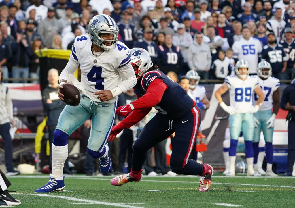 Oct 17, 2021; Foxborough, Massachusetts, USA; Dallas Cowboys quarterback Dak Prescott (4) under pressure from New England Patriots outside linebacker Matt Judon (9) in the first half at Gillette Stadium. Mandatory Credit: David Butler II-USA TODAY Sports