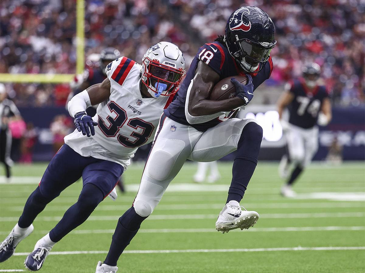 Oct 10, 2021; Houston, Texas, USA; Houston Texans wide receiver Chris Conley (18) runs with the ball after a reception as New England Patriots cornerback Joejuan Williams (33) defends during the second quarter at NRG Stadium. Mandatory Credit: Troy Taormina-USA TODAY Sports
