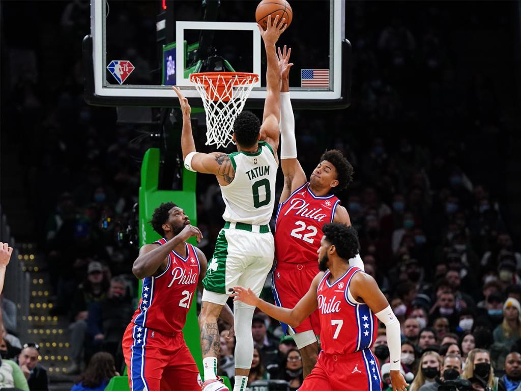 Dec 20, 2021; Boston, Massachusetts, USA; Boston Celtics forward Jayson Tatum (0) shoots against Philadelphia 76ers guard Matisse Thybulle (22) and Philadelphia 76ers center Joel Embiid (21) in the second quarter at TD Garden. Mandatory Credit: David Butler II-USA TODAY Sports