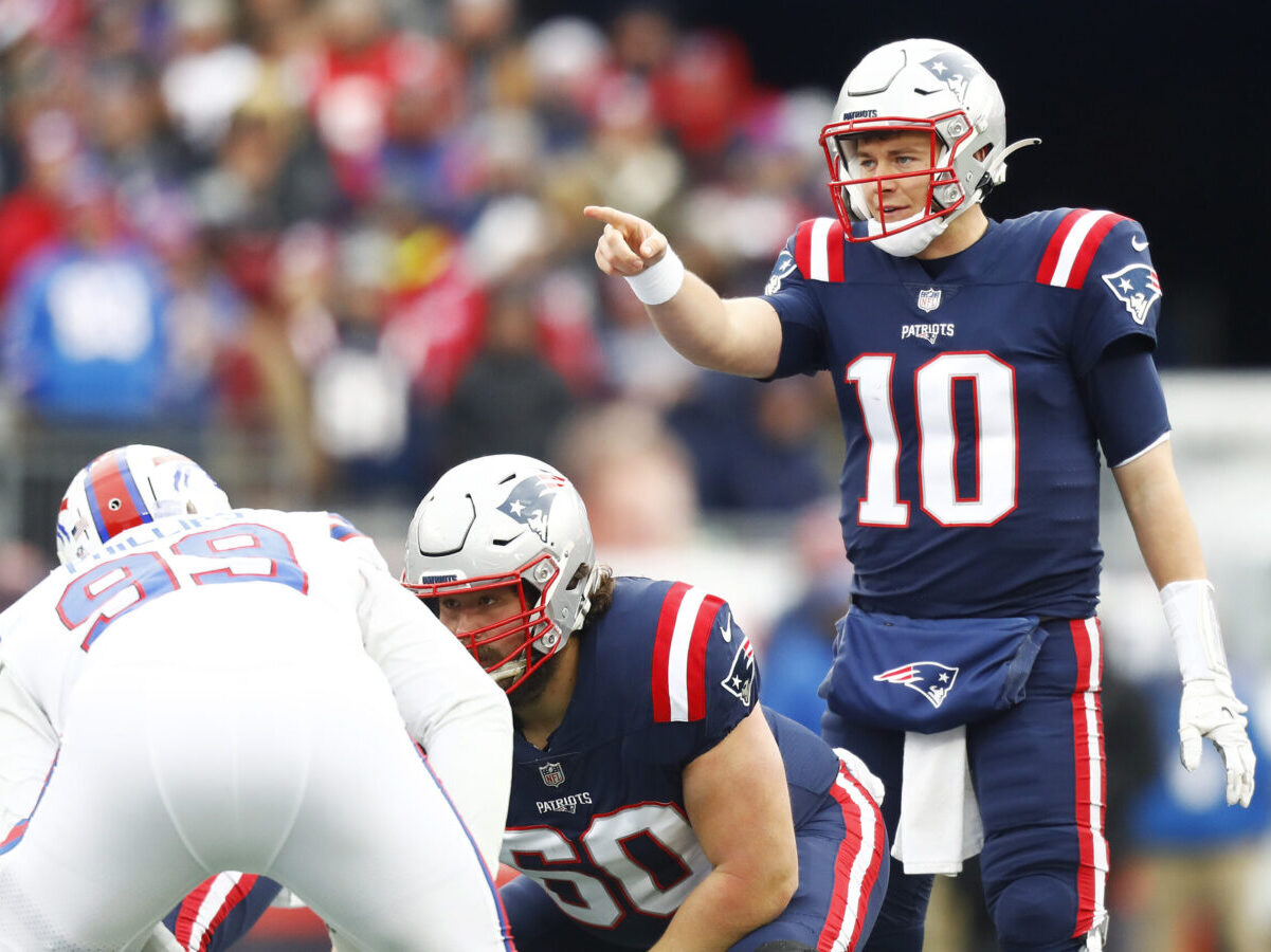 FOXBOROUGH, MASSACHUSETTS - DECEMBER 26: Mac Jones #10 of the New England Patriots calls a play at the line during the first quarter against the Buffalo Bills at Gillette Stadium on December 26, 2021 in Foxborough, Massachusetts. (Photo by Omar Rawlings/Getty Images)