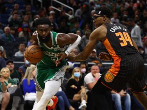 Feb 6, 2022; Orlando, Florida, USA; Boston Celtics guard Jaylen Brown (7) drives to the basket as Orlando Magic center Wendell Carter Jr. (34) defends during the second half at Amway Center. Mandatory Credit: Kim Klement-USA TODAY Sports