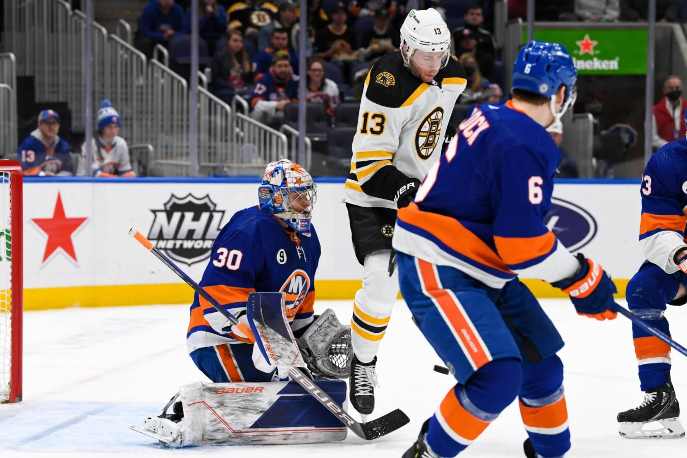 Feb 17, 2022; Elmont, New York, USA;  New York Islanders goaltender Ilya Sorokin (30) makes a save as he is screened by Boston Bruins center Charlie Coyle (13) during the first period at UBS Arena. Mandatory Credit: Dennis Schneidler/USA TODAY Sports