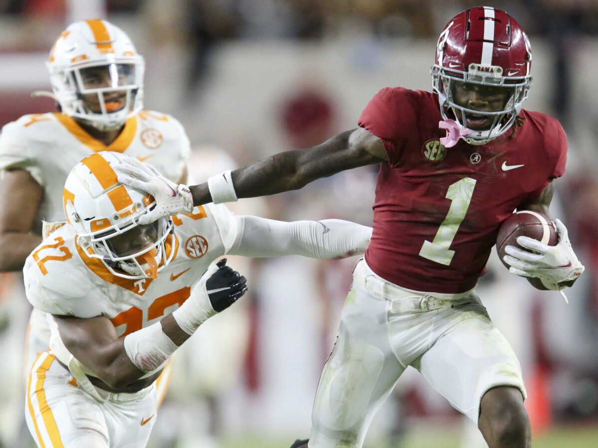 Oct 23, 2021; Tuscaloosa, Alabama, USA; Alabama Crimson Tide wide receiver Jameson Williams (1) uses a stiff arm to try to break away from Tennessee Volunteers defensive back Jaylen McCollough (22) at Bryant-Denny Stadium. Alabama won 52-24. Mandatory Credit: Gary Cosby Jr.-USA TODAY Sports