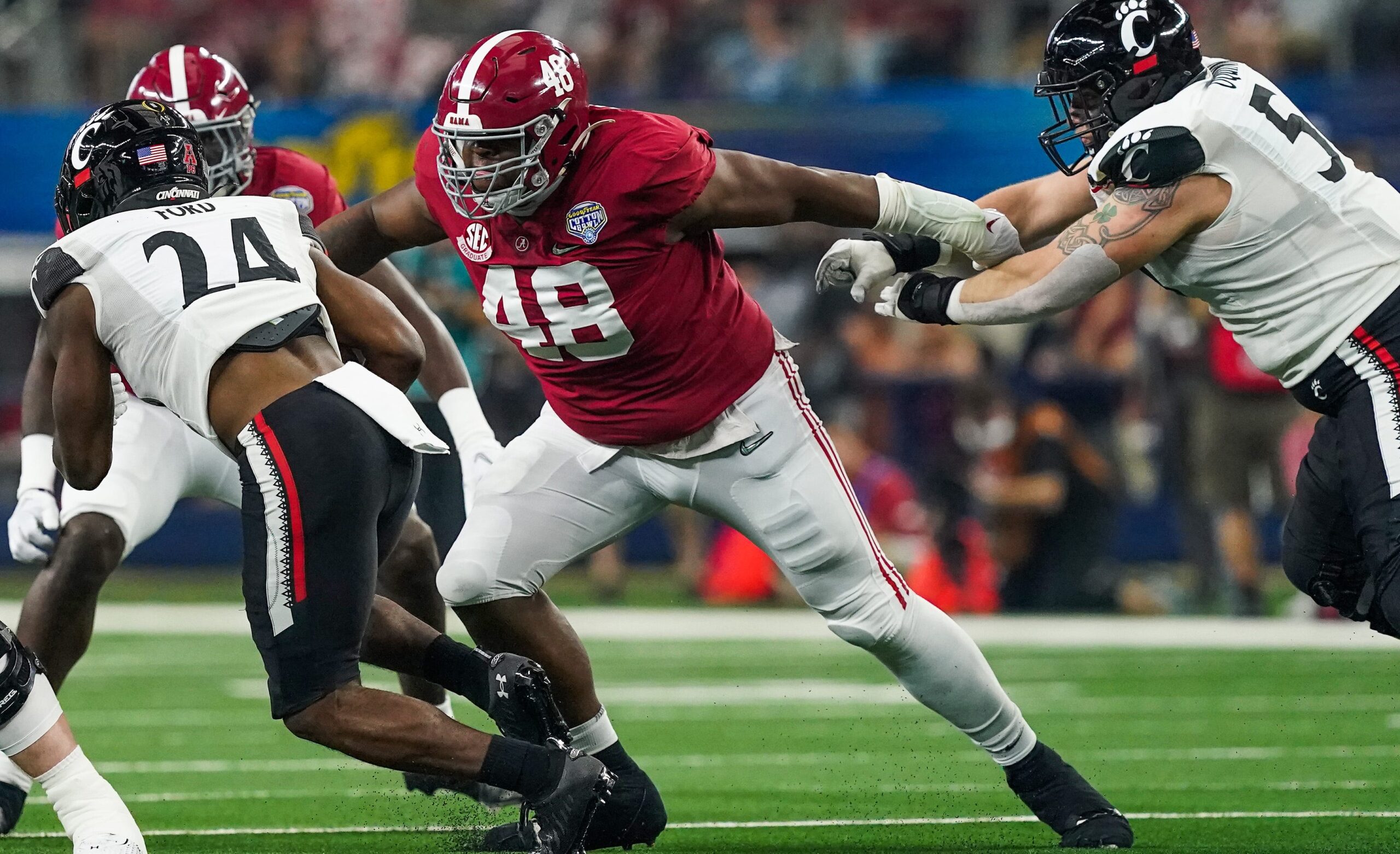 Alabama defensive lineman Phidarian Mathis (48) tackles Cincinnati running back Jerome Ford (24) in the 2021 College Football Playoff Semifinal game at the 86th Cotton Bowl in AT&T Stadium in Arlington, Texas Friday, Dec. 31, 2021. [Staff Photo/Gary Cosby Jr.]  College Football Playoffs Alabama Vs Cincinnati