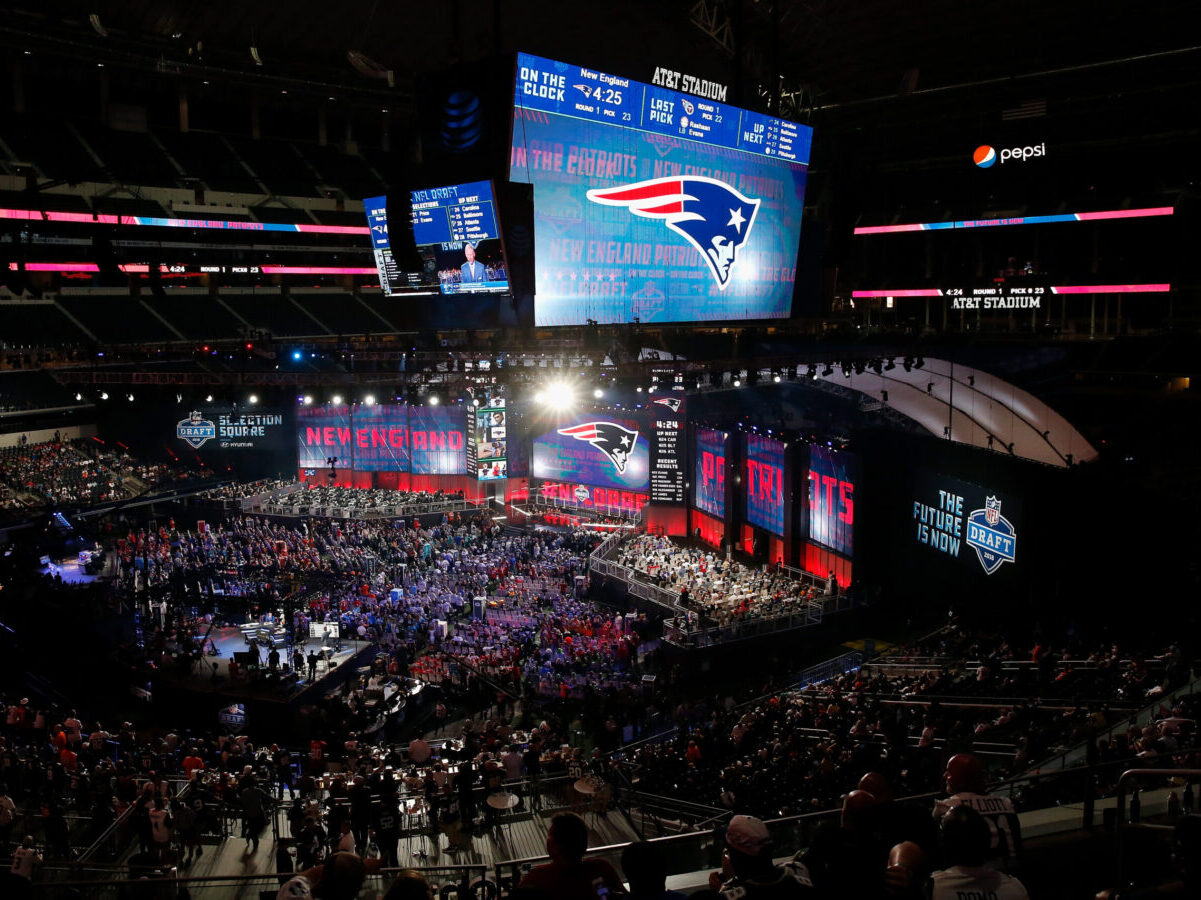 The New England Patriots logo is seen on a video board during the first round of the 2018 NFL Draft at AT&T Stadium on April 26, 2018 in Arlington, Texas. (Photo by Tim Warner/Getty Images)