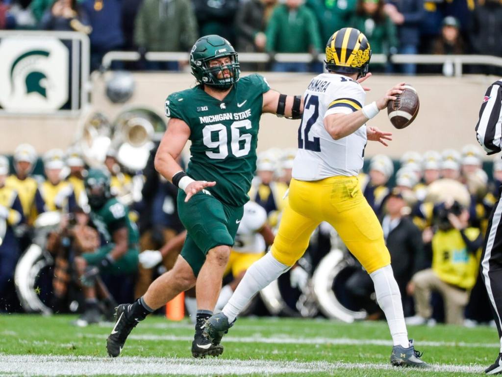 Michigan State defensive end Jacub Panasiuk (96) defends Michigan quarterback Cade McNamara (12) during the first half at Spartan Stadium in East Lansing on Saturday, Oct. 30, 2021. (Junfu Han/USA Today Network)