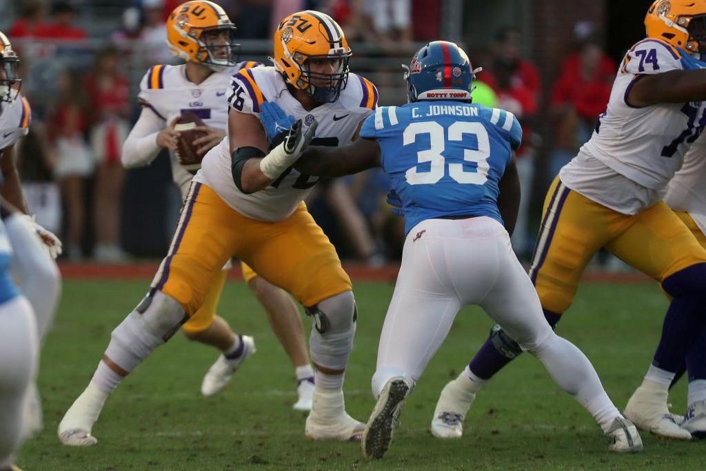 Oct 23, 2021; Oxford, Mississippi, USA; LSU Tigers offensive linemen Austin Deculus (76) blocks Mississippi Rebels linebacker Cedric Johnson (33) during the second half at Vaught-Hemingway Stadium. Credit: Petre Thomas-USA TODAY Sports