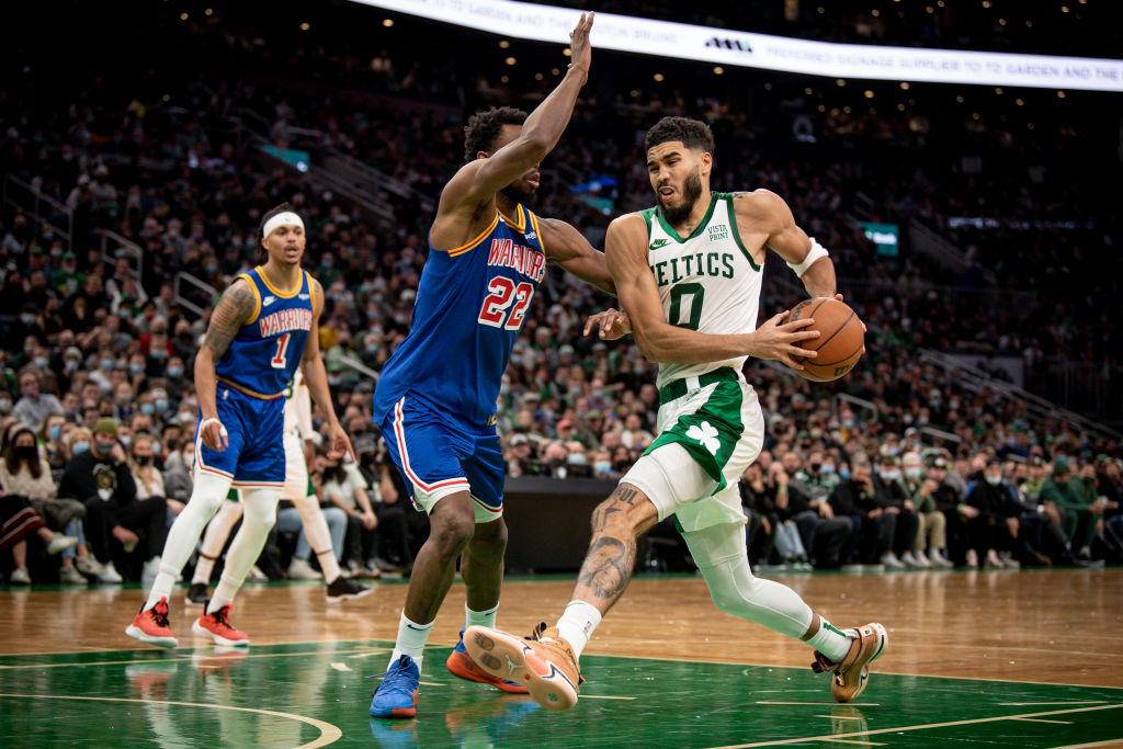 BOSTON, MASSACHUSETTS - DECEMBER 17: Jayson Tatum #0 of the Boston Celtics drives to the basket against Andrew Wiggins #22 of the Golden State Warriors at TD Garden on December 17, 2021 in Boston, Massachusetts. (Photo by Maddie Malhotra/Getty Images)