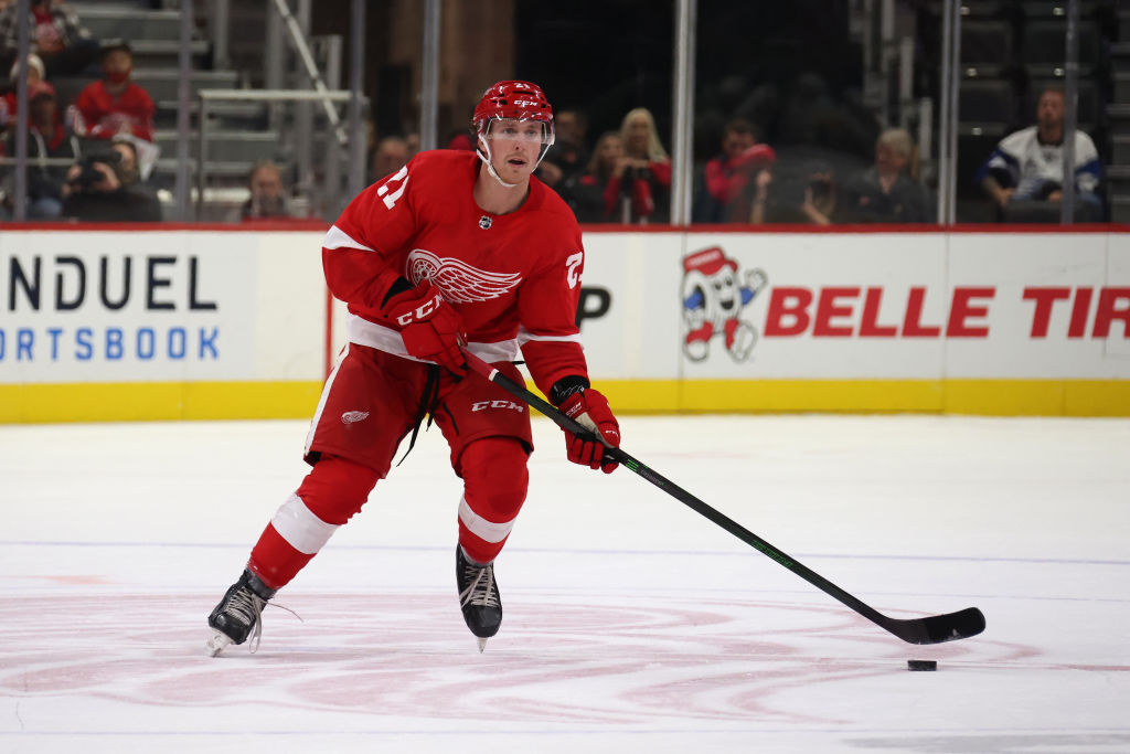 DETROIT, MICHIGAN - OCTOBER 07: Dan Renouf #21 of the Detroit Red Wings skates against the Pittsburgh Penguins during a preseason game at Little Caesars Arena on October 07, 2021 in Detroit, Michigan. (Photo by Gregory Shamus/Getty Images)