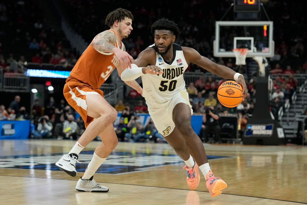 MILWAUKEE, WISCONSIN - MARCH 20: Trevion Williams #50 of the Purdue Boilermakers dribbles the ball in front of Christian Bishop #32 of the Texas Longhorns during the second half in the second round of the 2022 NCAA Men's Basketball Tournament at Fiserv Forum on March 20, 2022 in Milwaukee, Wisconsin. (Photo by Patrick McDermott/Getty Images)