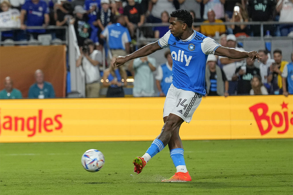 Jul 20, 2022; Charlotte, North Carolina, USA; Charlotte FC defender Christian Makoun (14) kicks a penalty kick after time elapsed against the Chelsea FC at Bank of America Stadium. Mandatory Credit: Jim Dedmon-USA TODAY Sports