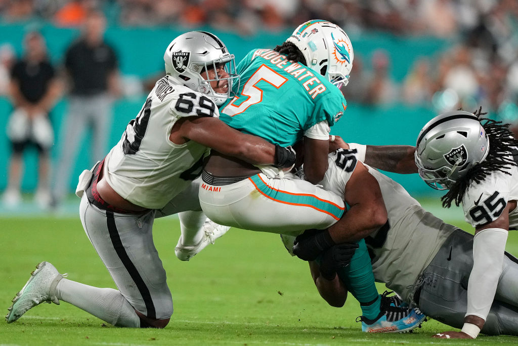 MIAMI GARDENS, FLORIDA - AUGUST 20: Myron Tagovailoa-Amosa #69 of the Las Vegas Raiders sacks quarterback Teddy Bridgewater #5 of the Miami Dolphins during the third quarter of the game at Hard Rock Stadium on August 20, 2022 in Miami Gardens, Florida. (Photo by Eric Espada/Getty Images)