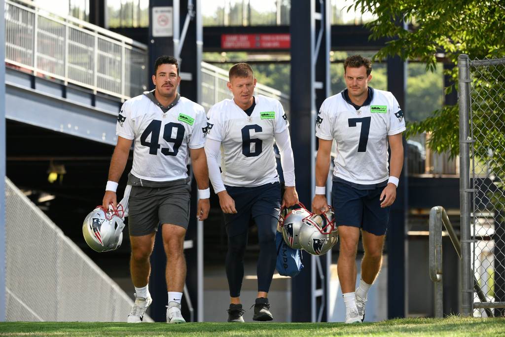 Jul 30, 2022; Foxborough, MA, USA; New England Patriots long snapper Joe Cardona (49), kicker Nick Folk (6) and punter Jake Bailey (7) walk together to the practice field at the Patriots training camp at Gillette Stadium. Credit: Eric Canha-USA TODAY Sports