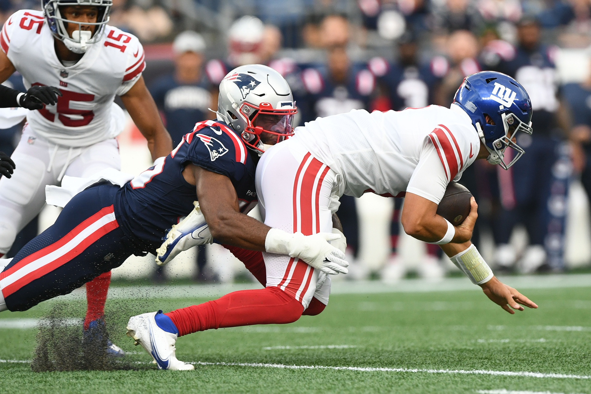Aug 11, 2022; Foxborough, Massachusetts, USA; New England Patriots linebacker Josh Uche (55) tackles New York Giants quarterback Daniel Jones (8) during the first half in a prison game at Gillette Stadium. Credit: Brian Fluharty-USA TODAY Sports