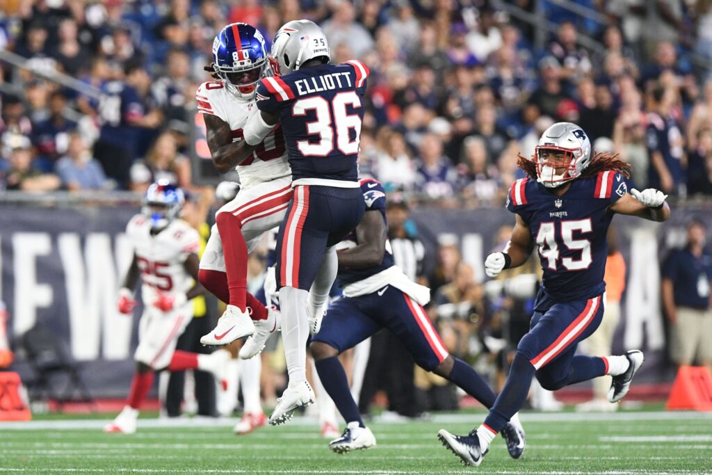 Aug 11, 2022; Foxborough, Massachusetts, USA; New York Giants wide receiver Richie James (80) and New England Patriots safety Jalen Elliott (36) battle for the ball during the first half in a preseason game at Gillette Stadium. Credit: Brian Fluharty-USA TODAY Sports