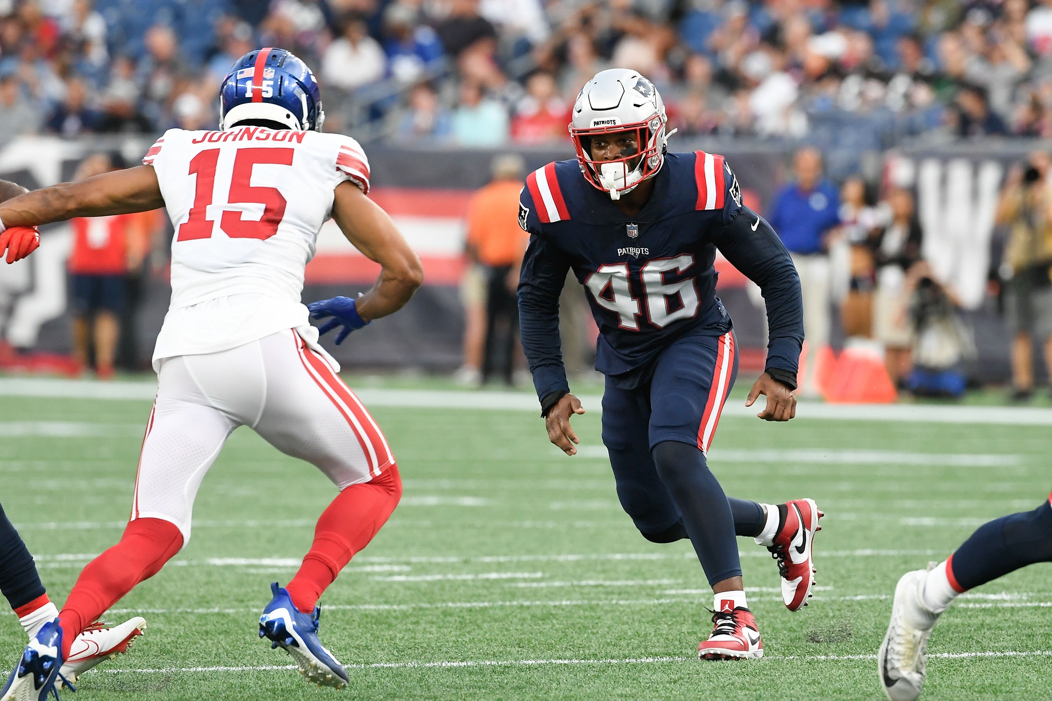 Aug 11, 2022; Foxborough, Massachusetts, USA; New England Patriots linebacker Raekwon McMillan (46) runs at New York Giants wide receiver Collin Johnson (15) during the first half of a preseason game at Gillette Stadium. Credit: Eric Canha-USA TODAY Sports